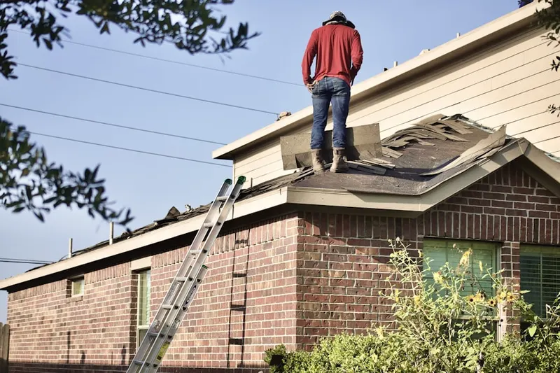 Professional roofer working on a residential roof in Evansburg Crossing